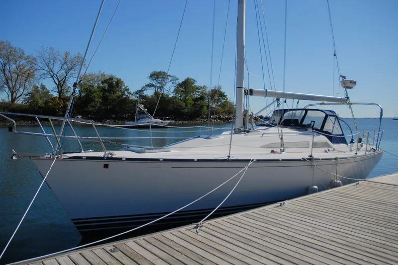 Slide: The Image of 2001 C&C 110 sailboat docked at a marina on a sunny day. - 2
