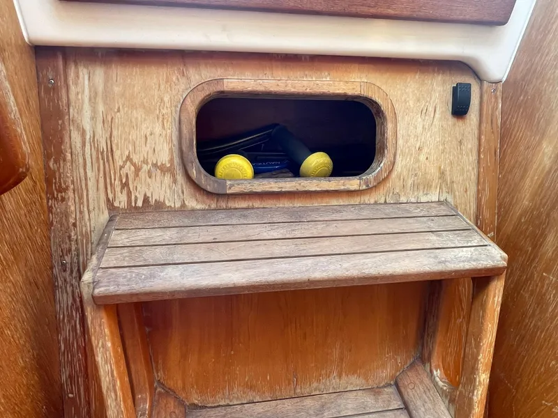 Slide: The Image of Wooden interior of a 2001 C&C 110 sailboat with storage compartment. - 20