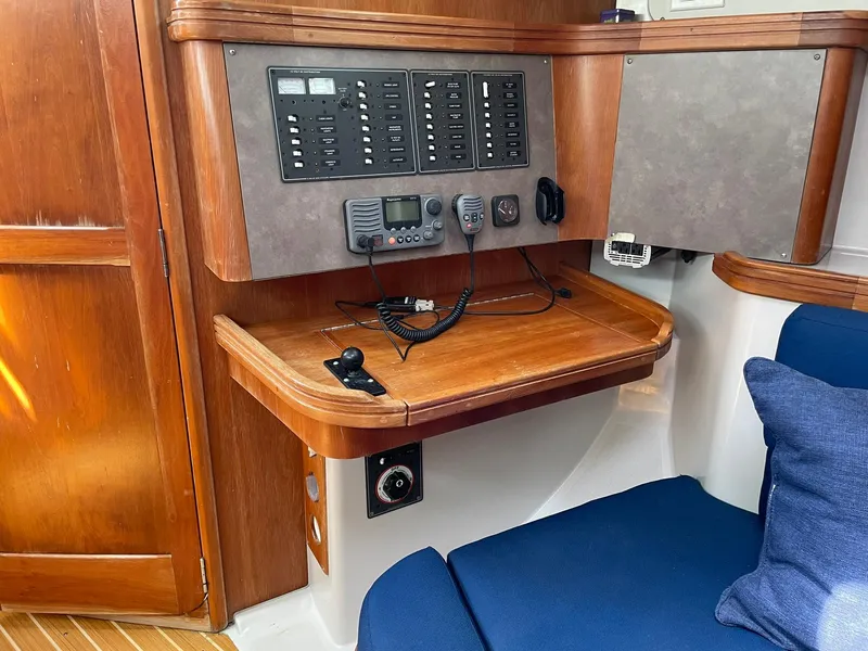 Slide: The Image of Navigation station on a 2001 C&C 110 sailboat with control panels and communication equipment. - 23