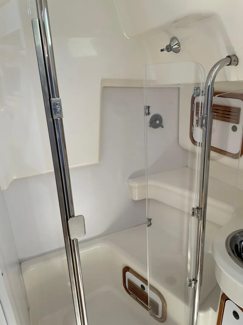 Slide: The Image of 2001 C&C 110 yacht bathroom with glass shower door and stainless steel fixtures. - 33