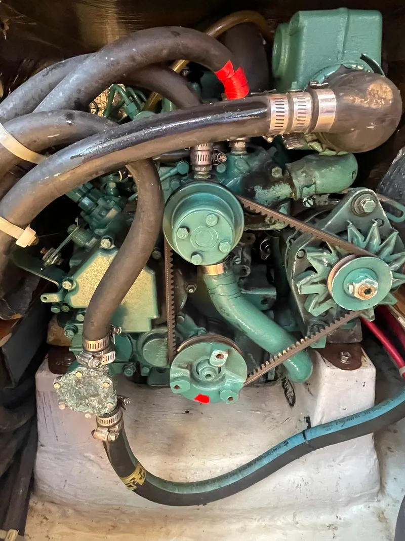 Slide: The Image of 2001 C&C 110 engine with hoses and belts in a boat's engine compartment. - 34