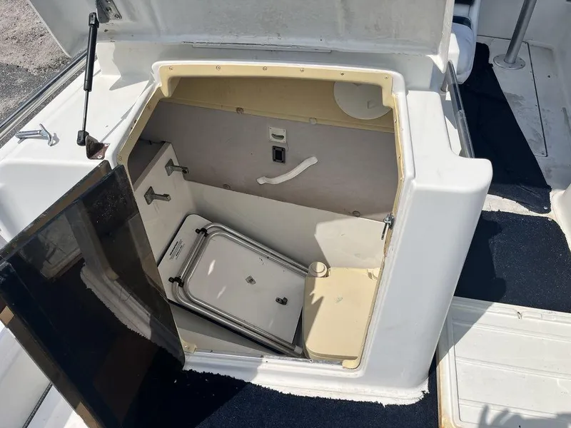 Slide: The Image of 1995 Hurricane FunDeck 240 boat interior with seating and storage area. - 12