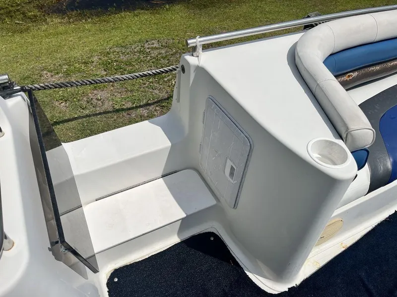 Slide: The Image of 1995 Hurricane FunDeck 240 boat interior with blue and white seating. - 14