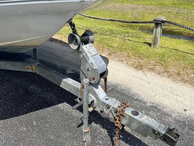 Slide: The Image of 1995 Hurricane FunDeck 240 boat interior with blue and white seating, V6 engine visible. - 17