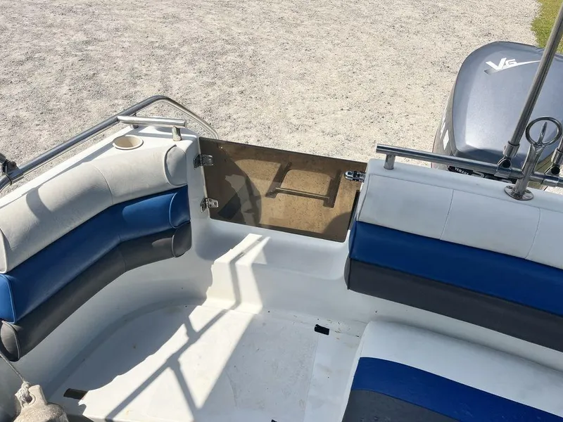 Slide: The Image of Interior of a 1995 Hurricane FunDeck 240 boat with blue and white seating. - 18