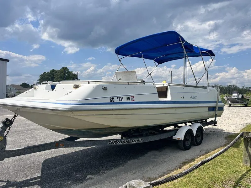 Slide: The Image of 1995 Hurricane FunDeck 240 boat interior with blue and white seating and storage compartment. - 3