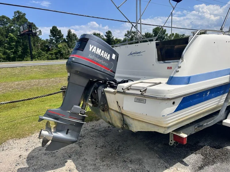 Slide: The Image of 1995 Hurricane FunDeck 240 boat interior with blue and white seating. - 6
