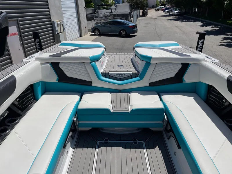 Slide: The Image of 2021 Nautique Super Air Nautique G25 boat interior with white and teal seating. - 10