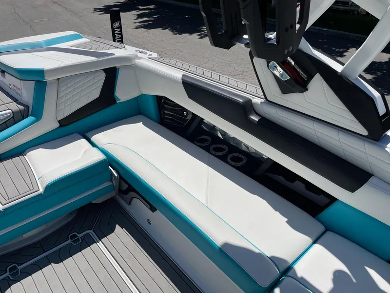 Slide: The Image of 2021 Nautique Super Air Nautique G25 interior seating with teal and white upholstery. - 11