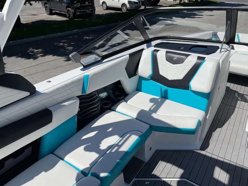 Slide: The Image of 2021 Nautique Super Air Nautique G25 interior with white and turquoise seating. - 12