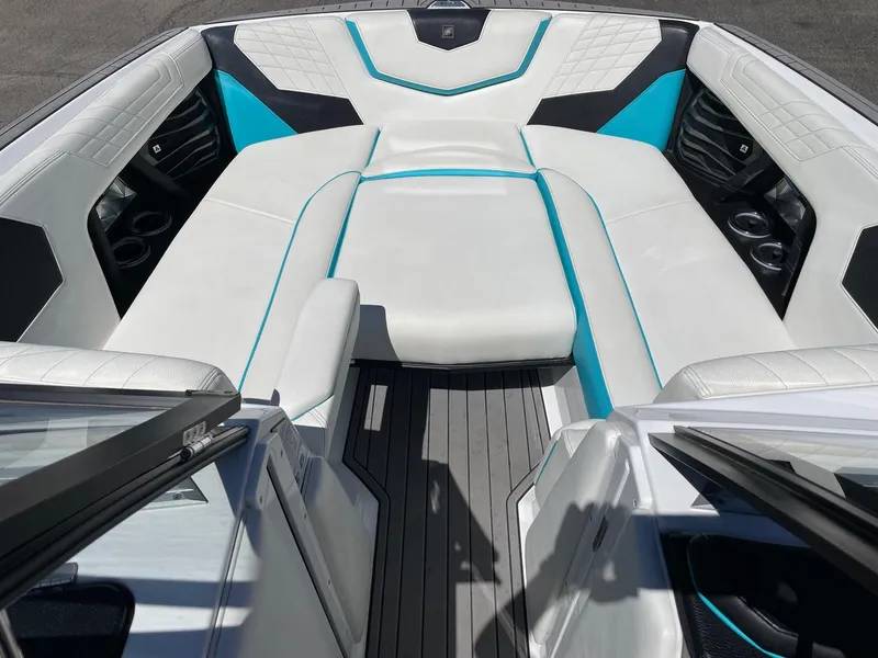 Slide: The Image of 2021 Nautique Super Air Nautique G25 boat interior with white and blue seating. - 13