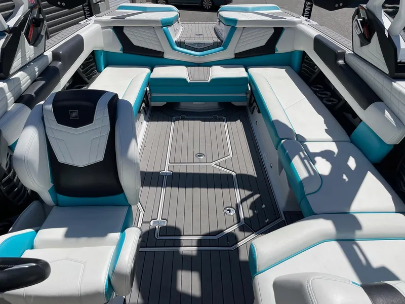 Slide: The Image of 2021 Nautique Super Air Nautique G25 interior with white and teal seating. - 14