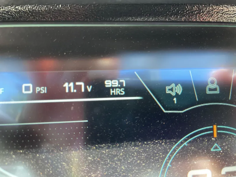 Slide: The Image of Close-up of 2021 Nautique Super Air Nautique G25 dashboard showing 99.7 hours and 11.7 volts. - 15