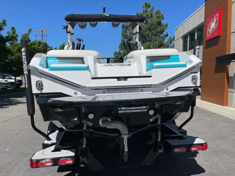 Slide: The Image of 2021 Nautique Super Air Nautique G25 boat rear view in a parking lot. - 5