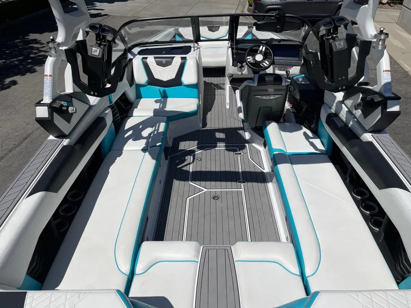 Slide: The Image of 2021 Nautique Super Air Nautique G25 interior with white and teal seating. - 7