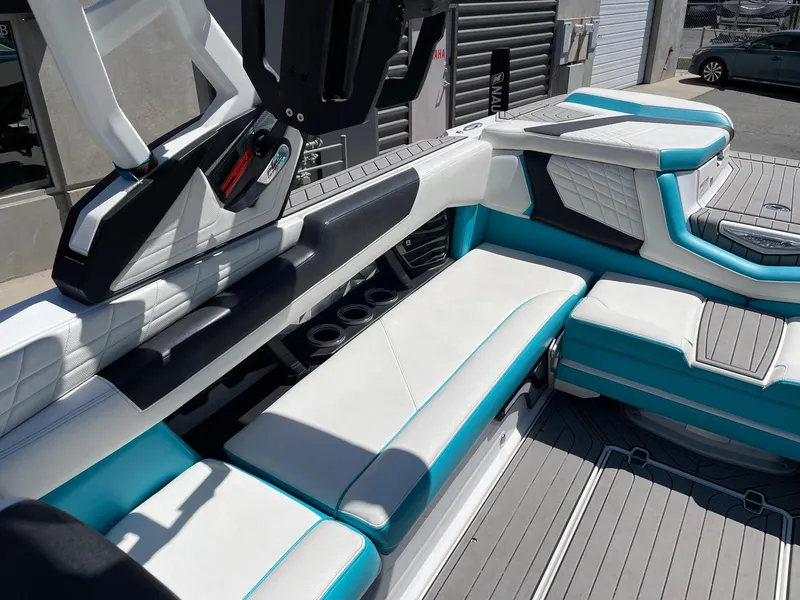 Slide: The Image of 2021 Nautique Super Air Nautique G25 interior with white and teal seating. - 9