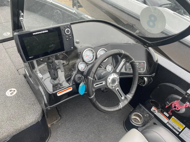 Slide: The Image of 2019 Nitro ZV19 Sport boat dashboard with steering wheel and Humminbird fish finder. - 14