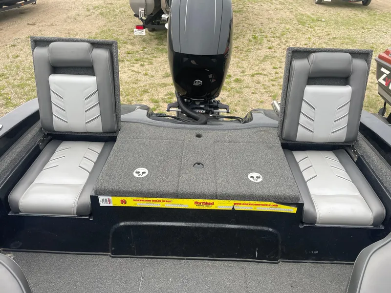 Slide: The Image of 2019 Nitro ZV19 Sport boat interior with gray seating and motor. - 6