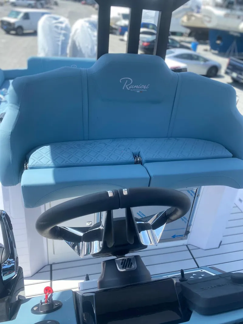 Slide: The Image of 2025 Ranieri CAYMAN 38.0 EXECUTIVE boat helm with blue seating and steering wheel. - 14