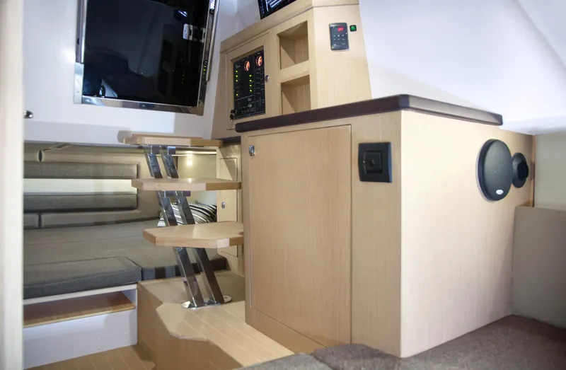 Slide: The Image of Interior of 2025 Ranieri CAYMAN 38.0 EXECUTIVE yacht with modern wooden stairs and control panel. - 28