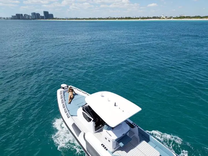 Slide: The Image of 2025 Ranieri CAYMAN 38.0 EXECUTIVE cruising on clear blue waters near a distant shoreline. - 5
