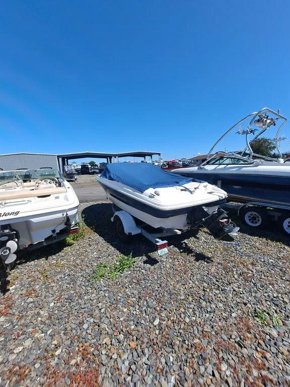 Slide: The Image of 2001 Bayliner 185 Capri Sport BR boat on a trailer in a boatyard. - 1