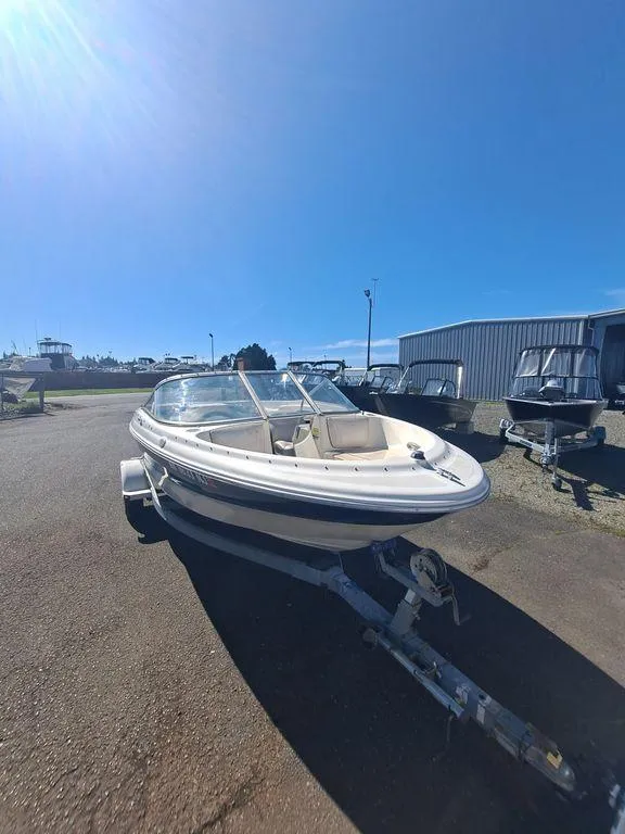 Slide: The Image of 2001 Bayliner 185 Capri Sport BR boat on a trailer in a sunny outdoor setting. - 5