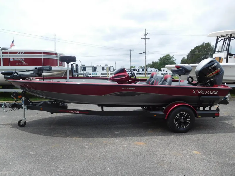 Slide: The Image of 2024 Vexus AVX 1880 V2 fishing boat in red and gray on trailer. - 1