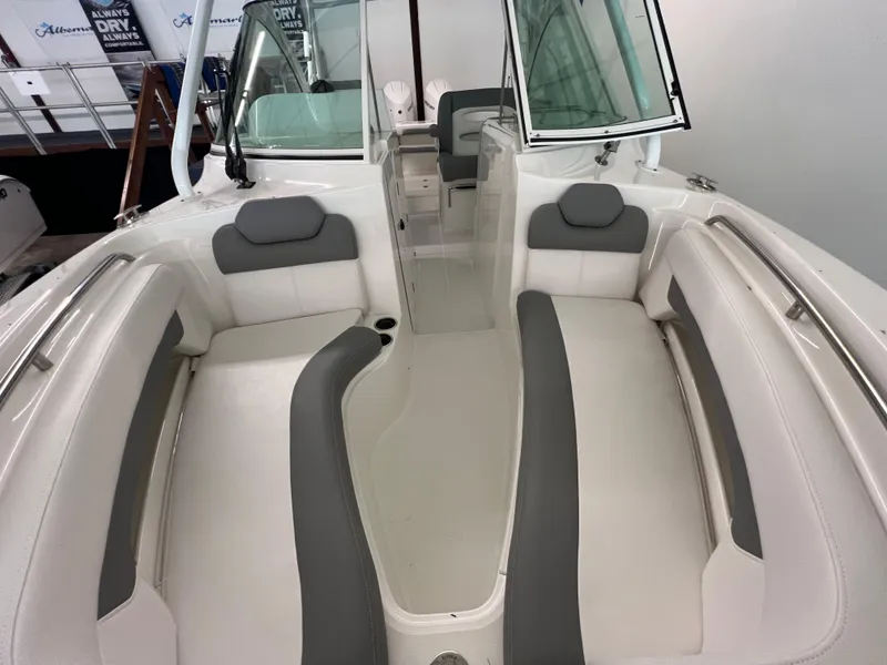 Slide: The Image of 2025 Albemarle 27 Dual Console boat interior with white and gray seating. - 12