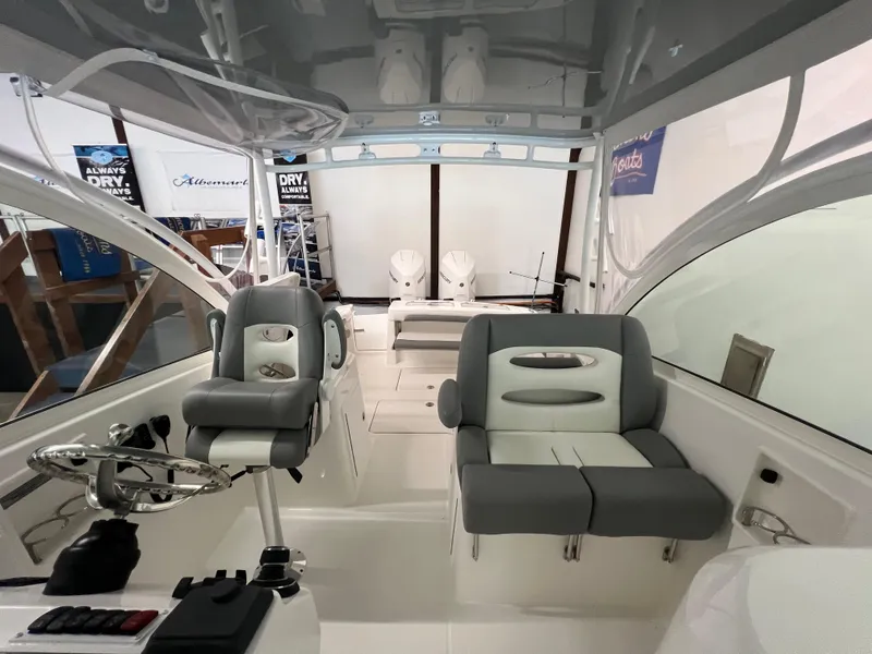 Slide: The Image of 2025 Albemarle 27 Dual Console boat interior with seating and steering wheel. - 14