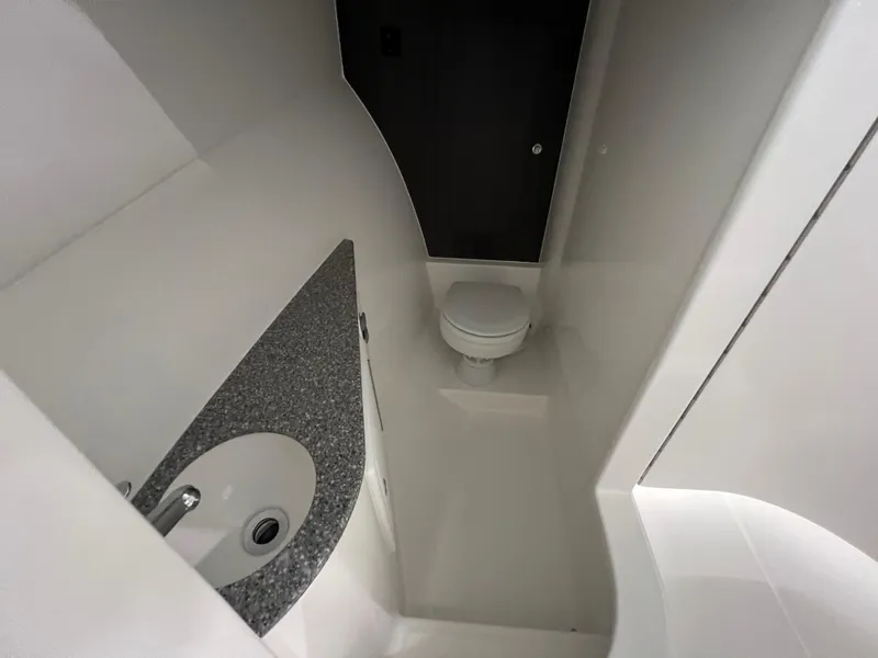 Slide: The Image of 2025 Albemarle 27 Dual Console boat bathroom with sink and toilet. - 15