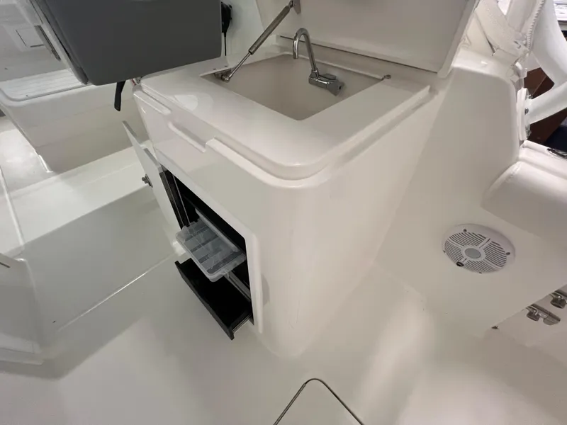 Slide: The Image of 2025 Albemarle 27 Dual Console boat interior with sink and storage compartments. - 4