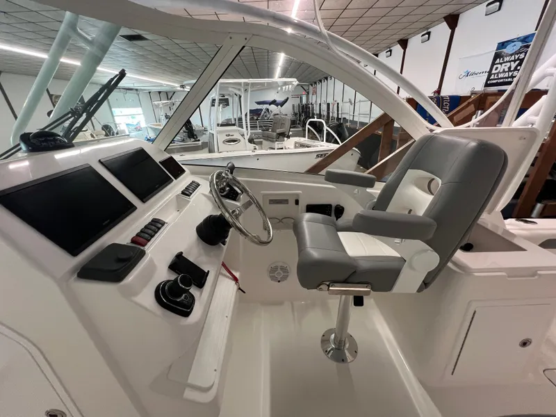 Slide: The Image of 2025 Albemarle 27 Dual Console boat interior with modern helm and seating. - 9