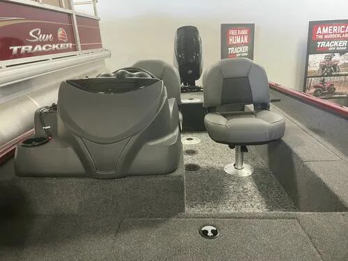 Slide: The Image of 2024 Tracker Super Guide V-16 SC boat interior with seating and control console. - 10