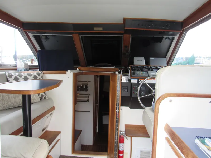 Slide: The Image of Interior of 1997 Norstar 302 boat with helm, seating, and wooden accents. - 23