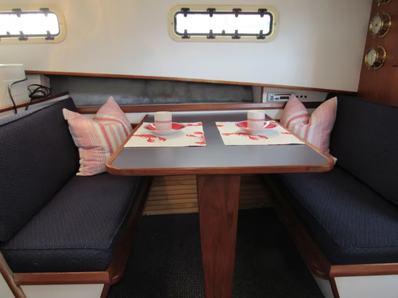 Slide: The Image of Cozy dining area in a 1997 Norstar 302 boat with nautical-themed decor. - 28