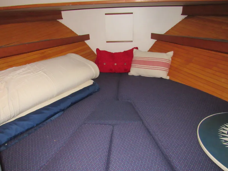 Slide: The Image of Cozy cabin interior of 1997 Norstar 302 boat with blue cushions and decorative pillows. - 29