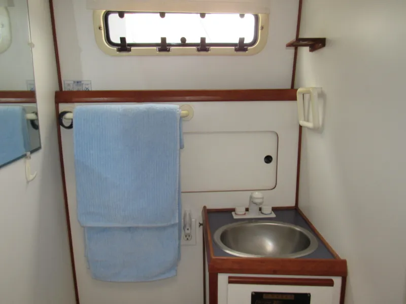 Slide: The Image of Compact bathroom in a 1997 Norstar 302 boat with sink and towel rack. - 30