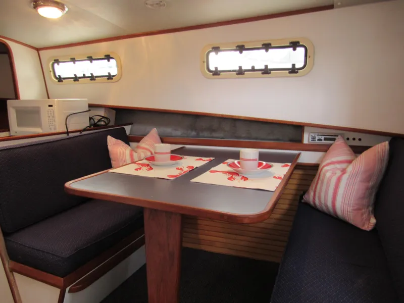 Slide: The Image of Cozy dining area in a 1997 Norstar 302 boat with nautical decor. - 33