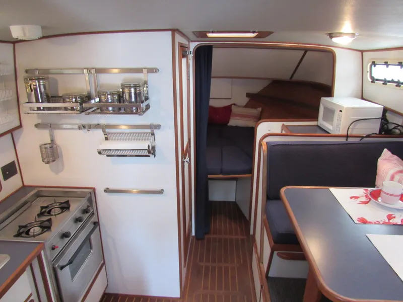 Slide: The Image of 1997 Norstar 302 boat interior with kitchen, dining area, and sleeping quarters. - 35