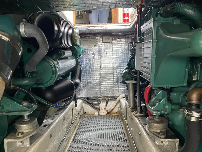 Slide: The Image of Engine room of a 1997 Norstar 302 boat, featuring dual green engines and metallic insulation. - 36