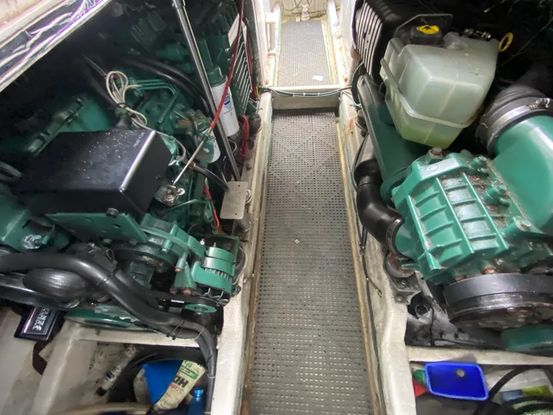 Slide: The Image of Engine compartment of a 1997 Norstar 302 boat, showcasing dual green engines and components. - 40