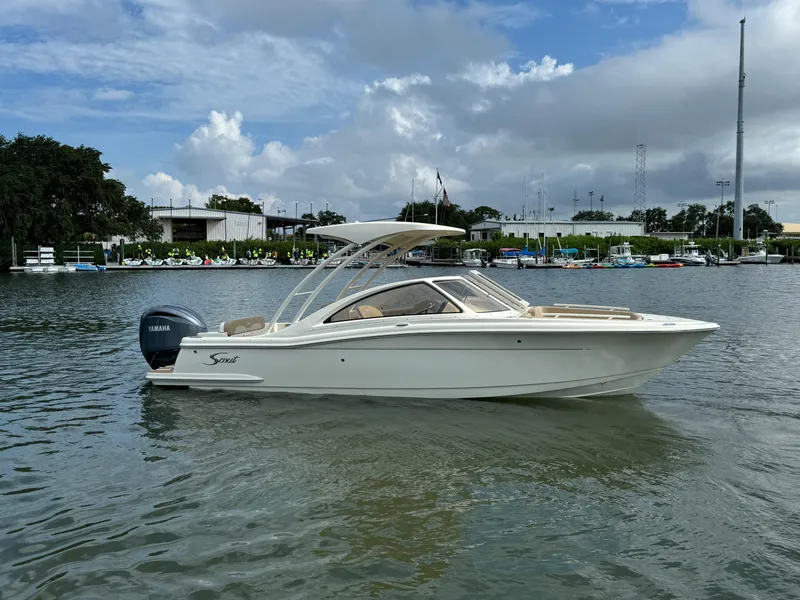 Slide: The Image of 2024 Scout 240 Dorado boat on water with Yamaha outboard motor. - 0