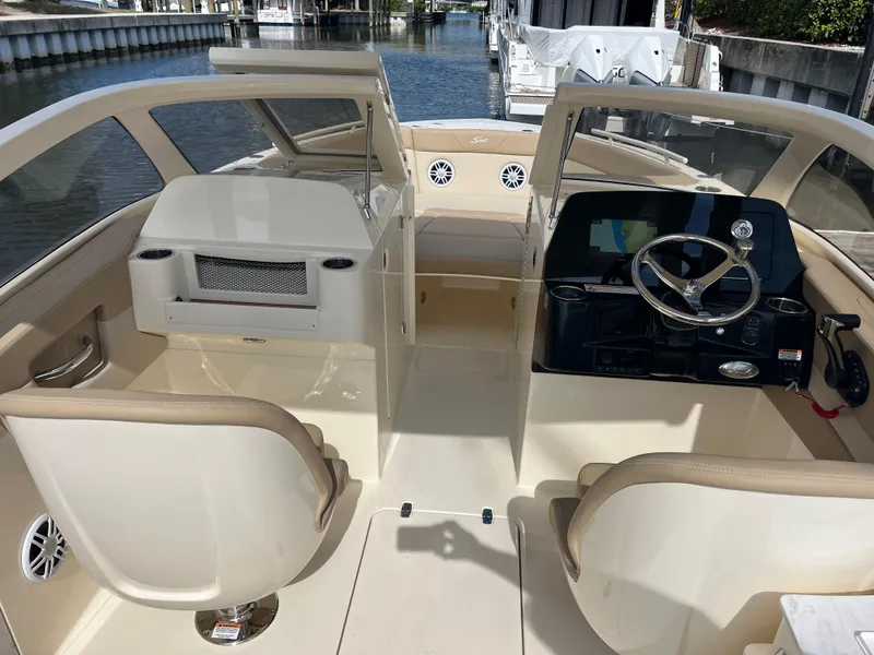 Slide: The Image of 2024 Scout 240 Dorado boat interior with dual helm seats and spacious cockpit. - 10
