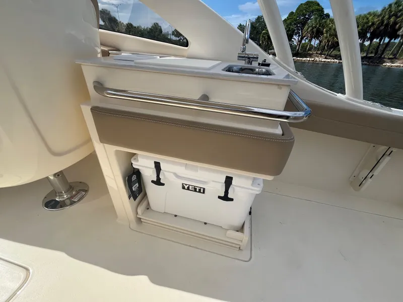 Slide: The Image of 2024 Scout 240 Dorado boat interior with Yeti cooler and sink. - 14
