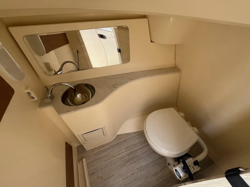 Slide: The Image of 2024 Scout 240 Dorado boat bathroom with sink, mirror, and toilet. - 19