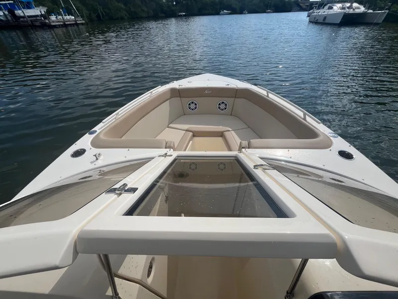 Slide: The Image of 2024 Scout 240 Dorado boat on calm water with spacious seating area. - 21