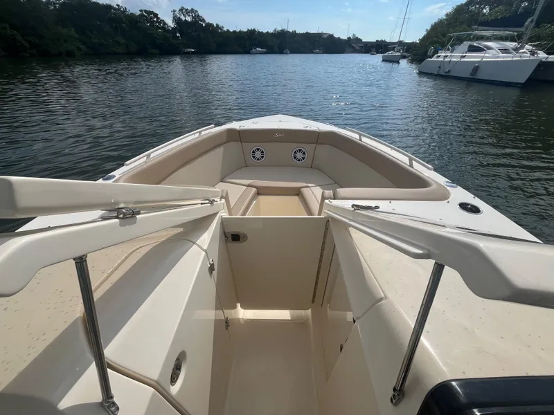 Slide: The Image of 2024 Scout 240 Dorado boat interior, bow seating area on calm water. - 22