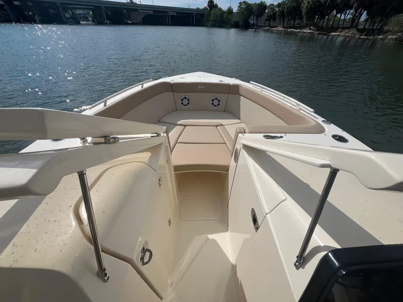 Slide: The Image of 2024 Scout 240 Dorado boat interior with seating, on a calm lake. - 24