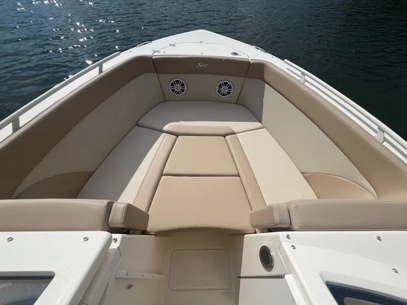 Slide: The Image of 2024 Scout 240 Dorado boat with beige seating and water in the background. - 25